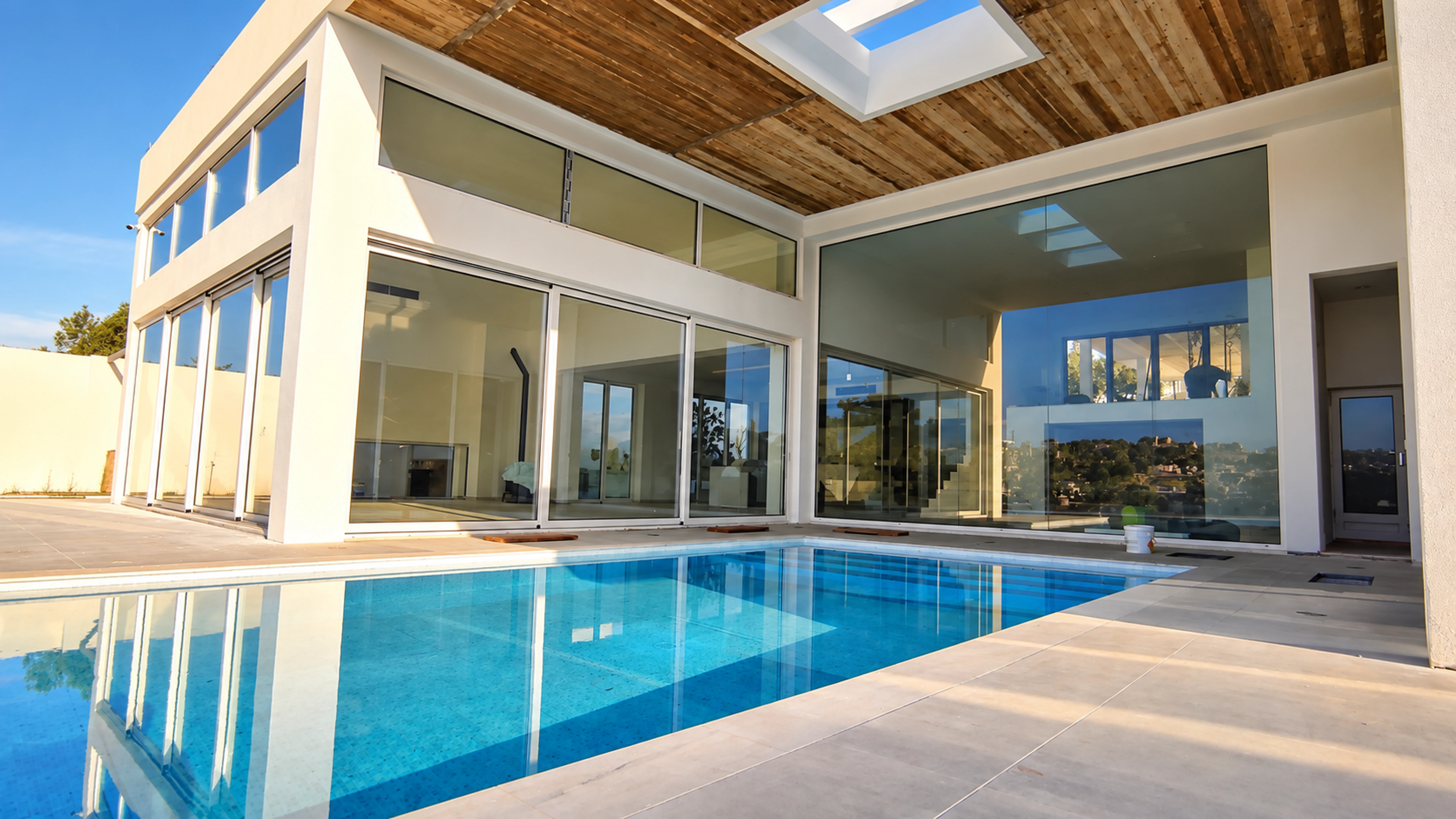 Villa pool terrace with a concrete soffit, rooflight and sliding doors