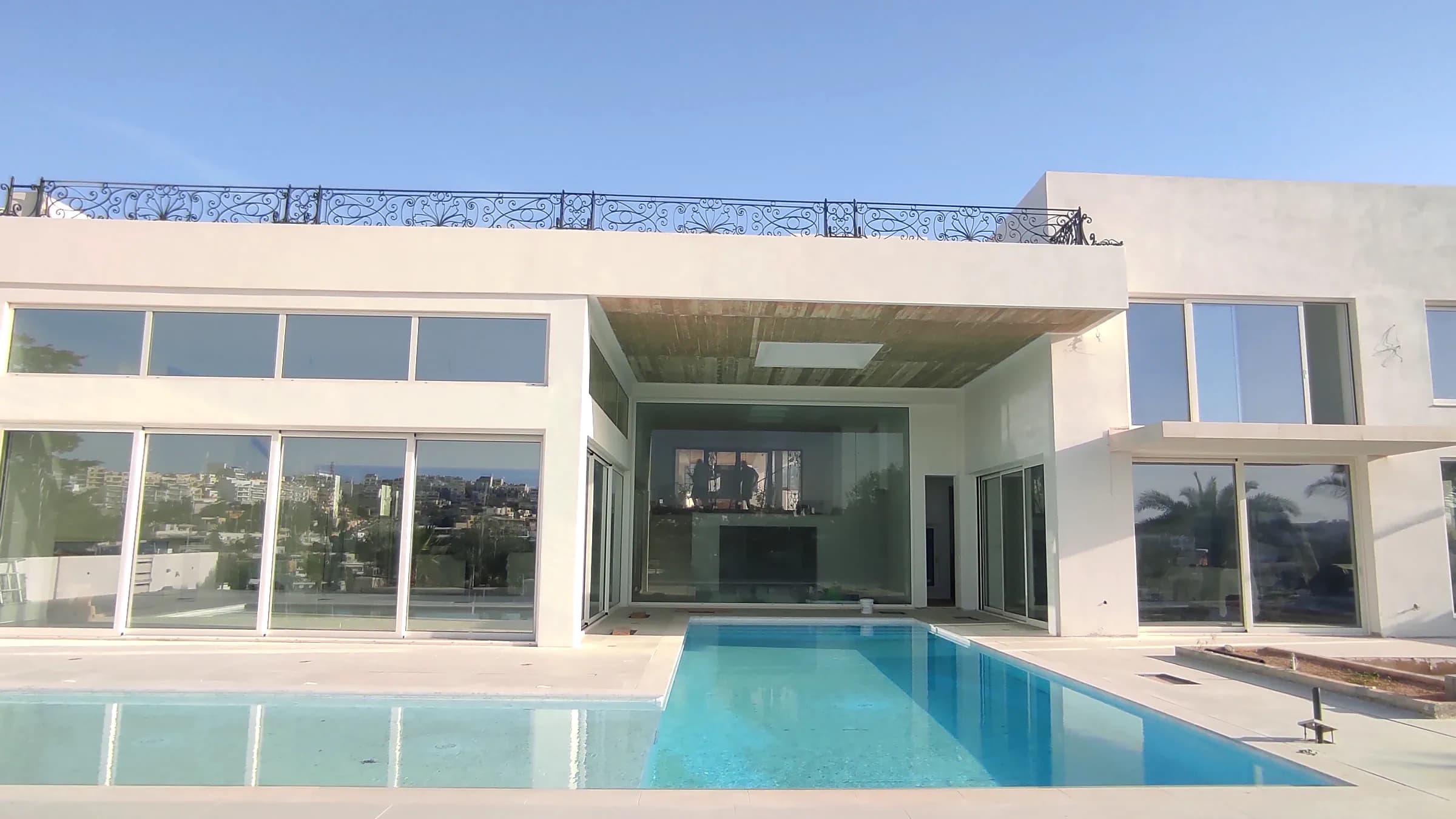 Contemporary villa with a pool leading to its glazed living space