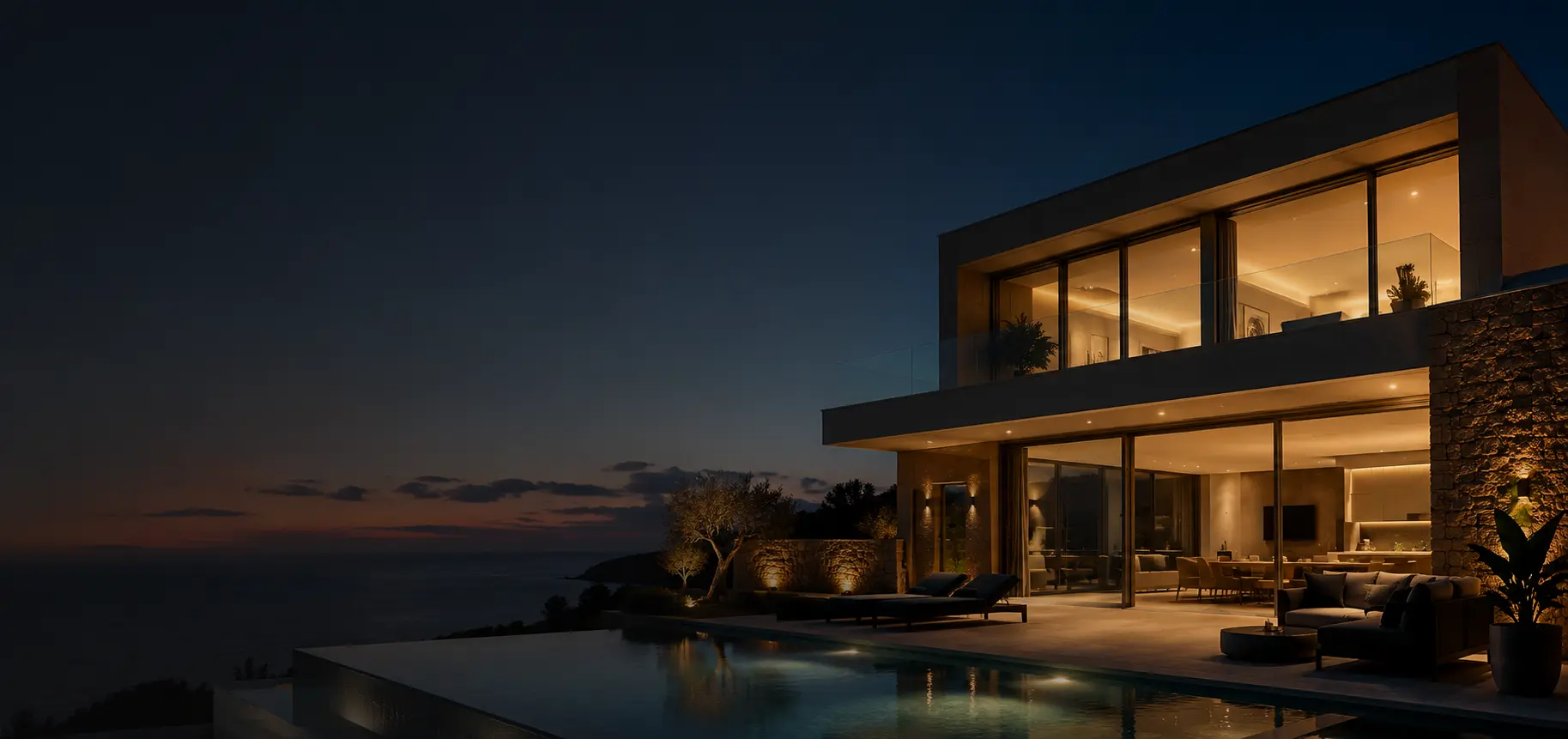 Aluminium sliding doors opening a living space onto a terrace at dusk