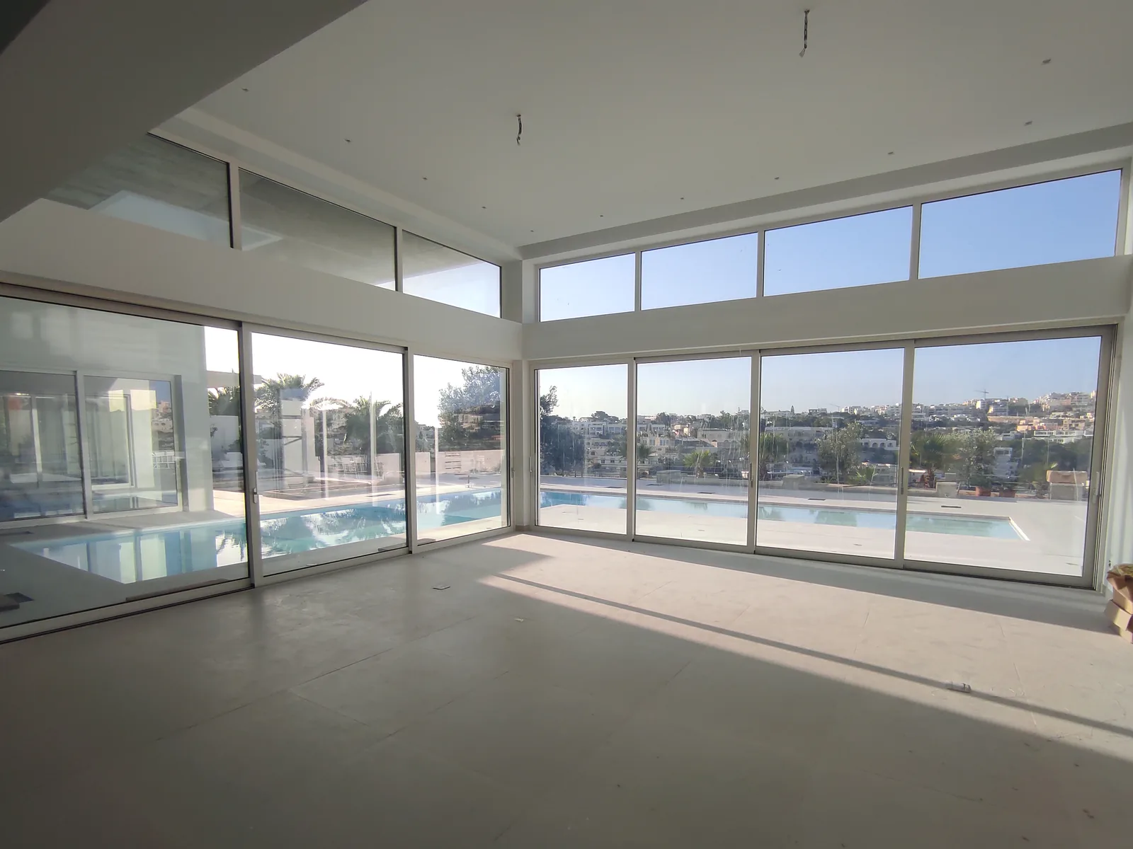 Interior view through the full-height glazing at Seafront Villa